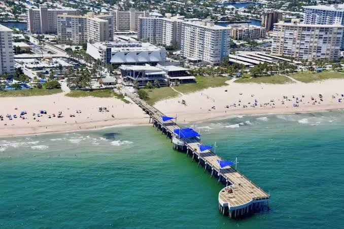 Aerial view of Fisher Family Pier extending into the ocean beside Pompano Beach